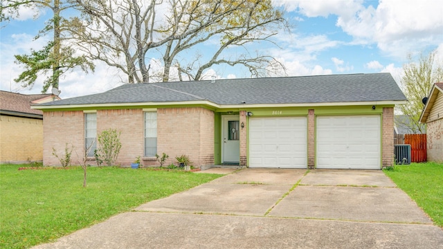 ranch-style home featuring brick siding, a garage, driveway, and a front yard