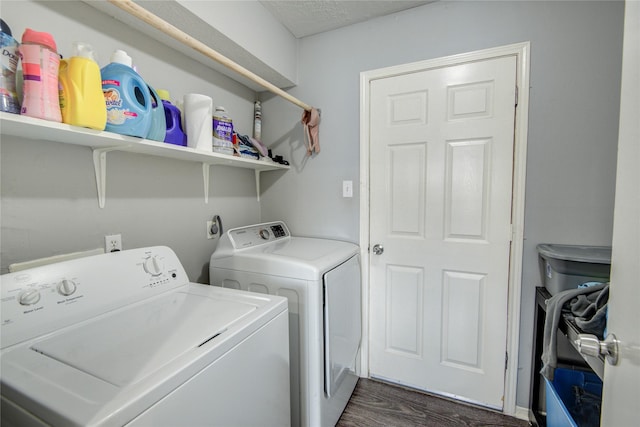 washroom featuring washer and clothes dryer, laundry area, and dark wood-style flooring