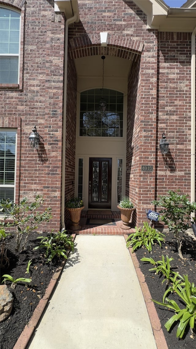 entrance to property with brick siding and french doors