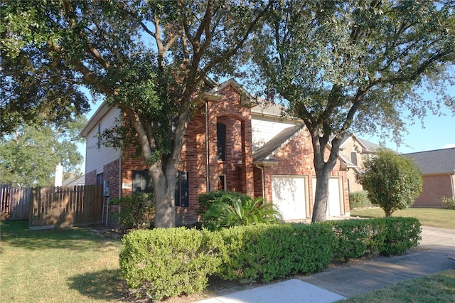 view of side of home with a garage, a yard, fence, and brick siding