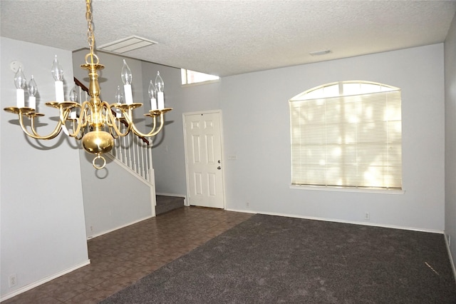 interior space featuring an inviting chandelier, visible vents, tile patterned floors, and a textured ceiling