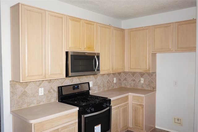 kitchen with light brown cabinetry, a textured ceiling, appliances with stainless steel finishes, light countertops, and decorative backsplash