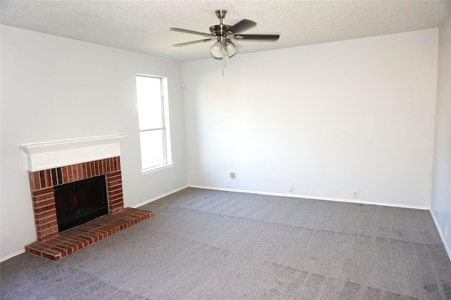 unfurnished living room with a ceiling fan, carpet, baseboards, a textured ceiling, and a brick fireplace