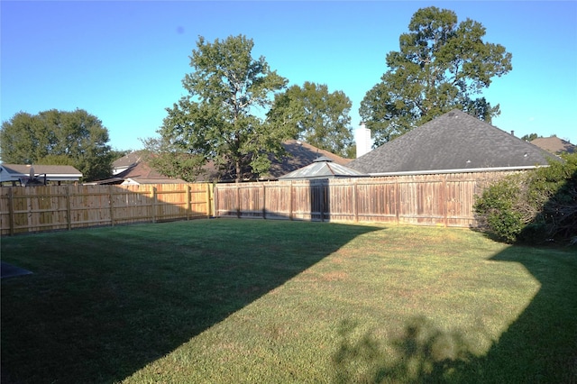 view of yard with a fenced backyard