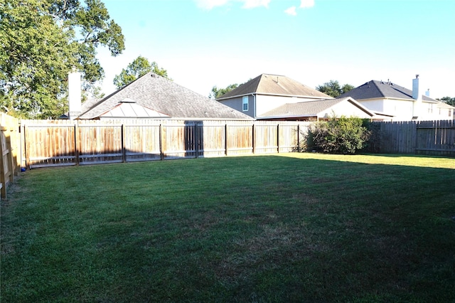 view of yard with a fenced backyard