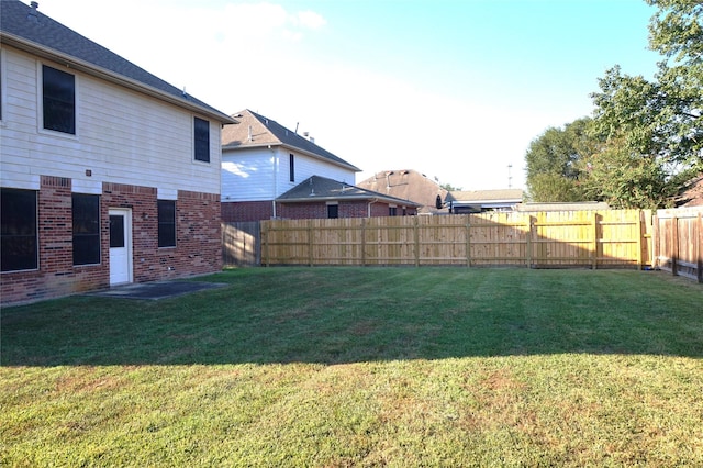 view of yard with a fenced backyard