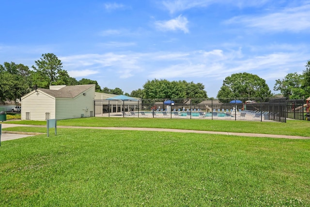 view of yard with a community pool and fence