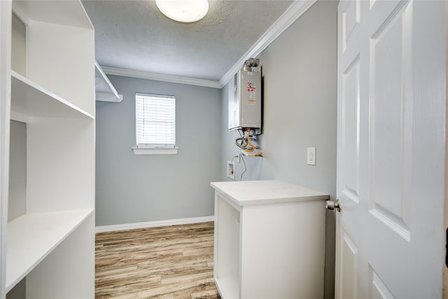 walk in closet with tankless water heater and wood finished floors