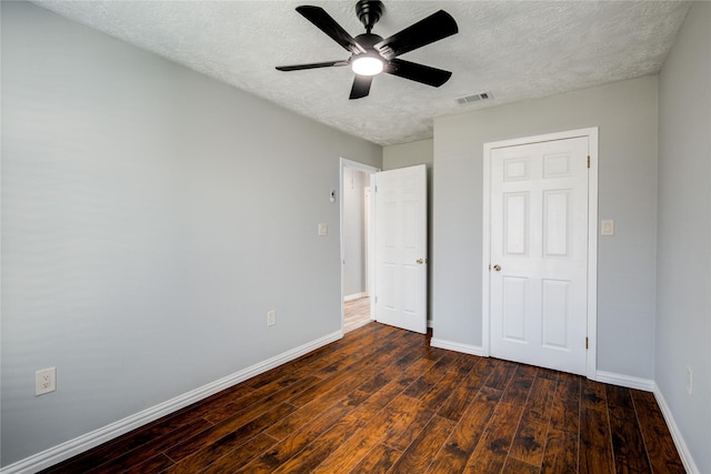 unfurnished bedroom with visible vents, baseboards, a textured ceiling, and hardwood / wood-style flooring