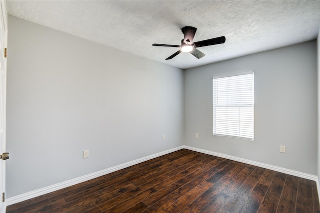 empty room with ceiling fan, baseboards, a textured ceiling, and dark wood finished floors