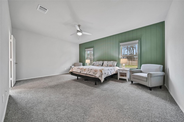 bedroom featuring visible vents, baseboards, ceiling fan, and carpet floors