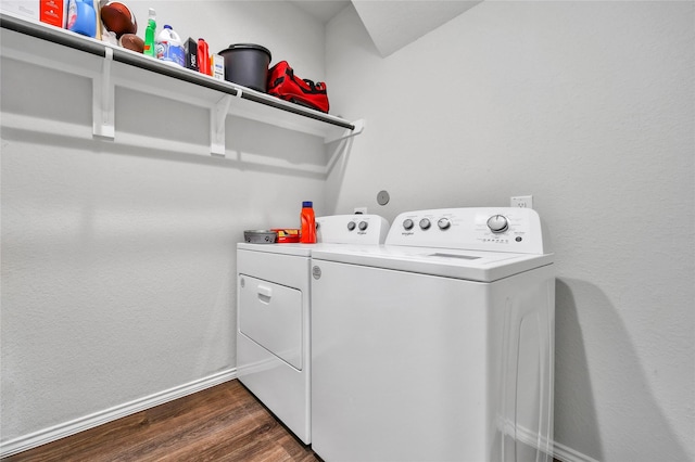 laundry room featuring laundry area, baseboards, dark wood-type flooring, and washer and clothes dryer