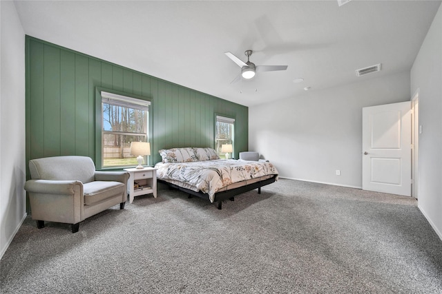 carpeted bedroom with visible vents, baseboards, and ceiling fan