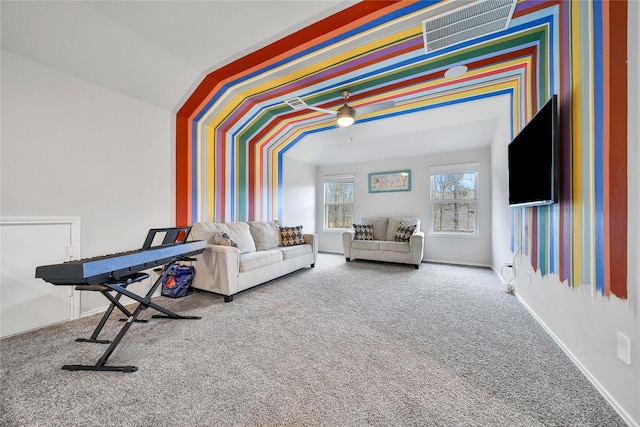 living area with visible vents, lofted ceiling, and carpet floors