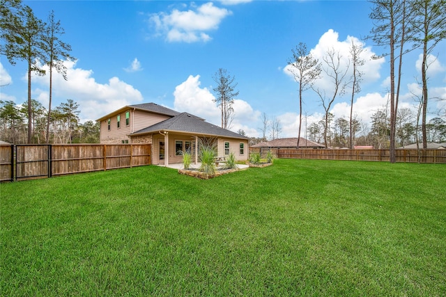 view of yard with a patio and a fenced backyard