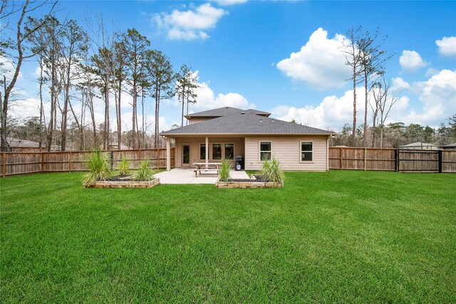 back of house with a patio, a fenced backyard, a lawn, and a shingled roof