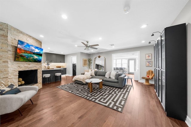 living area featuring wood finished floors, baseboards, a fireplace, recessed lighting, and ceiling fan