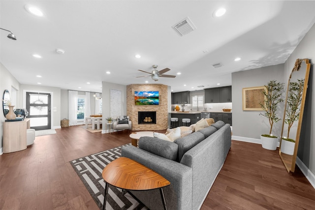 living area featuring recessed lighting, dark wood-style floors, and visible vents