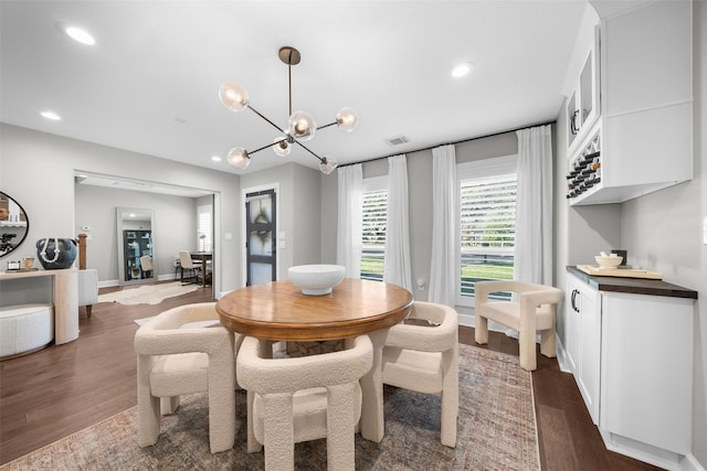 dining area featuring visible vents, baseboards, dark wood finished floors, recessed lighting, and a notable chandelier