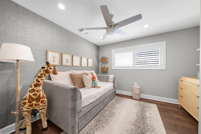 bedroom featuring recessed lighting, wallpapered walls, baseboards, and wood finished floors