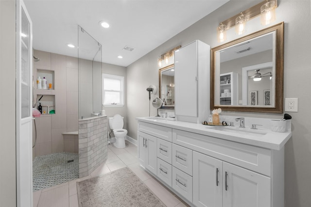 bathroom featuring walk in shower, toilet, visible vents, and a sink