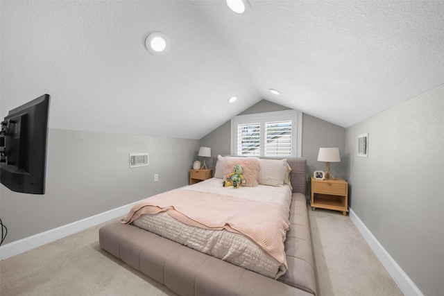 bedroom with vaulted ceiling, light colored carpet, visible vents, and a textured ceiling