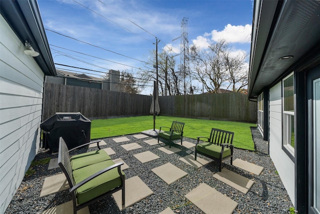 view of patio with area for grilling and a fenced backyard