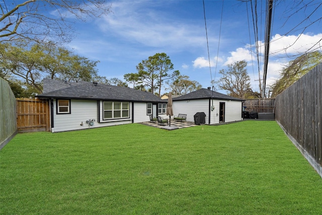 back of house with a lawn, a patio, and a fenced backyard