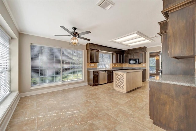 kitchen with visible vents, stainless steel dishwasher, a center island, black microwave, and light countertops