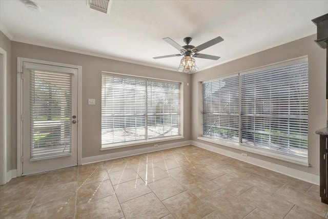 interior space with visible vents, plenty of natural light, a ceiling fan, and crown molding