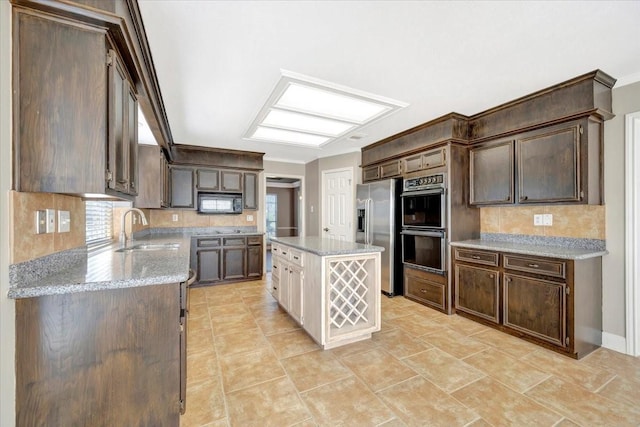 kitchen featuring backsplash, black microwave, double oven, stainless steel refrigerator with ice dispenser, and a sink