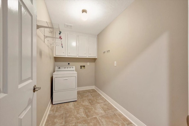 laundry room featuring visible vents, cabinet space, washer / clothes dryer, and baseboards