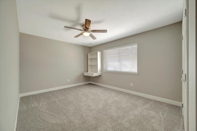 unfurnished room featuring carpet flooring, baseboards, and ceiling fan