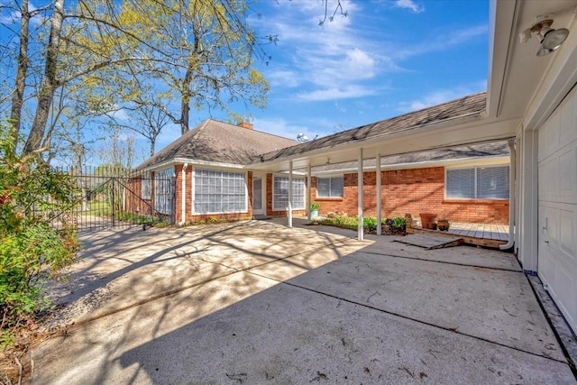 back of property featuring fence and brick siding