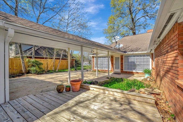 wooden deck with a patio and fence