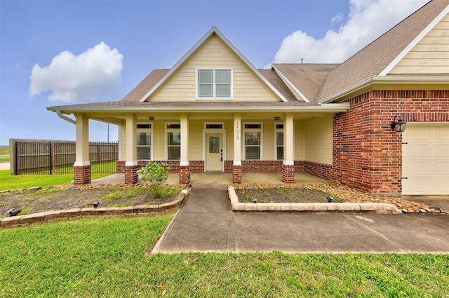 view of front of house with brick siding, a porch, fence, and an attached garage