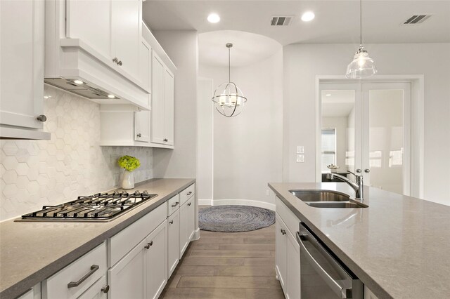 kitchen with visible vents, appliances with stainless steel finishes, white cabinetry, and a sink