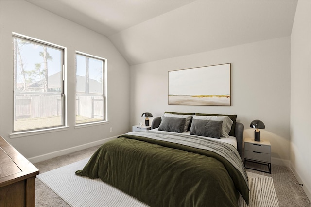 bedroom featuring baseboards, carpet floors, and vaulted ceiling