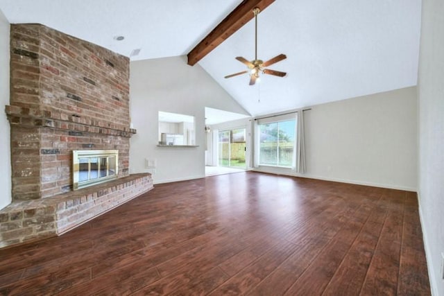 unfurnished living room featuring hardwood / wood-style floors, beamed ceiling, a brick fireplace, and ceiling fan