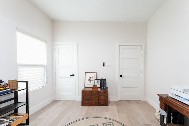 interior space with light wood-style flooring and baseboards