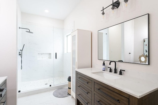 full bath with a marble finish shower, marble finish floor, and vanity