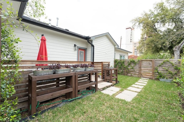 view of yard with outdoor dining space and fence