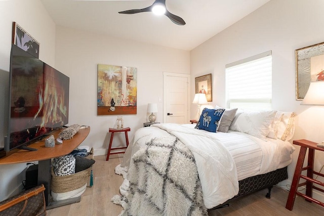 bedroom with a ceiling fan, baseboards, and wood finished floors