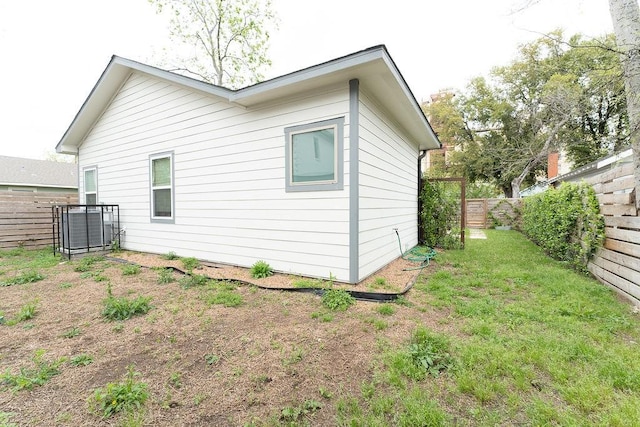 view of side of property with a fenced backyard and a lawn