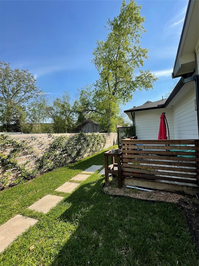 view of yard with a wooden deck and fence