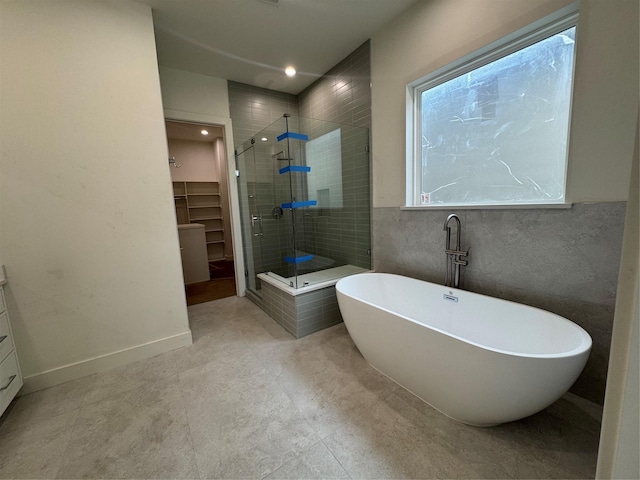 4403 Feagan, Houston, TX 77007 - full bathroom featuring a stall shower, a walk in closet, a freestanding bath, vanity, and recessed lighting