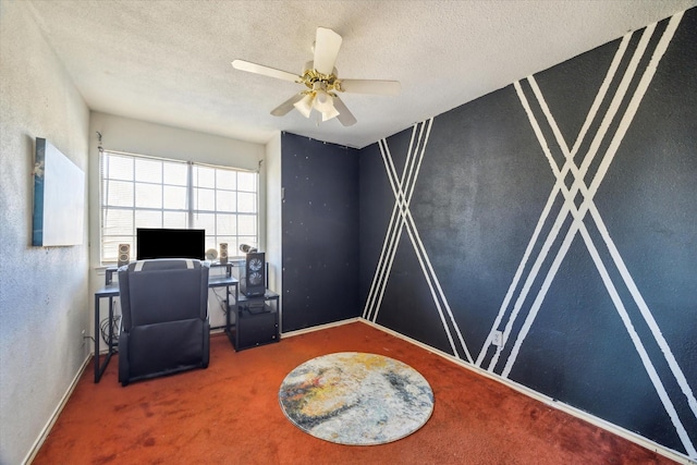 carpeted home office with a textured ceiling, a ceiling fan, and a textured wall