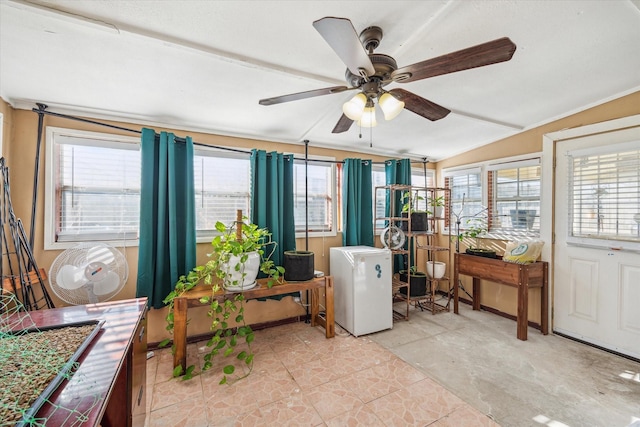 interior space featuring plenty of natural light, ceiling fan, and vaulted ceiling