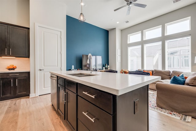 kitchen with visible vents, open floor plan, light countertops, and light wood-style flooring