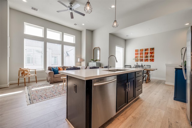 kitchen with visible vents, light wood-style flooring, dishwasher, and a sink